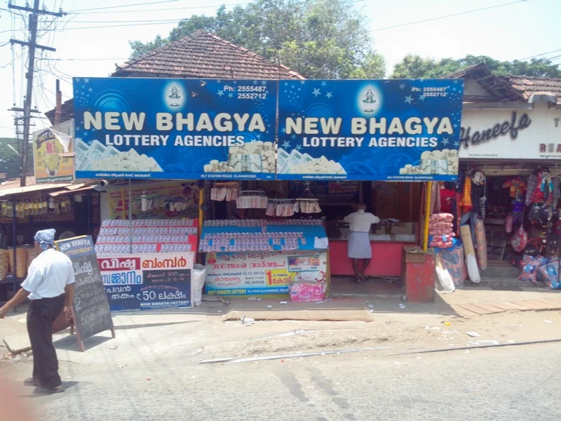 An actual Kerala lottery agency storefront in Palakkad, with ticket displays and Malayalam signage.